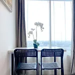 Minimalist 1Br Without Living Room Grand Kamala Lagoon Apartment By Travelio