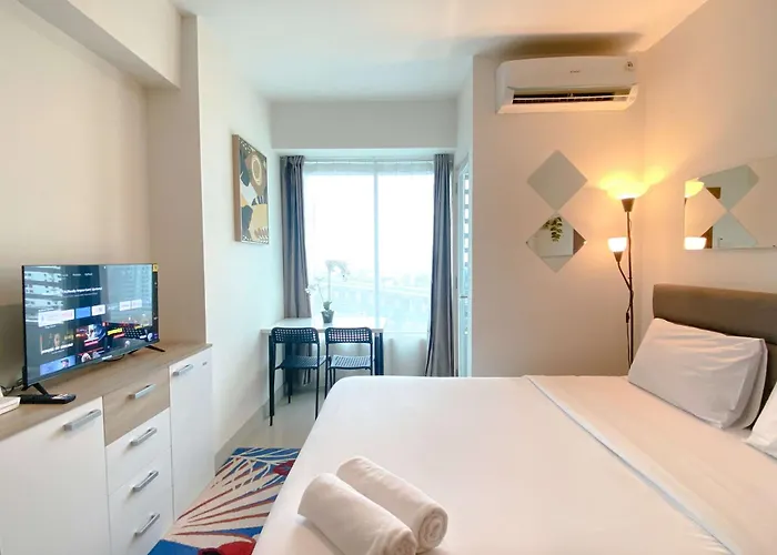 Minimalist 1Br Without Living Room Grand Kamala Lagoon Apartment By Travelio